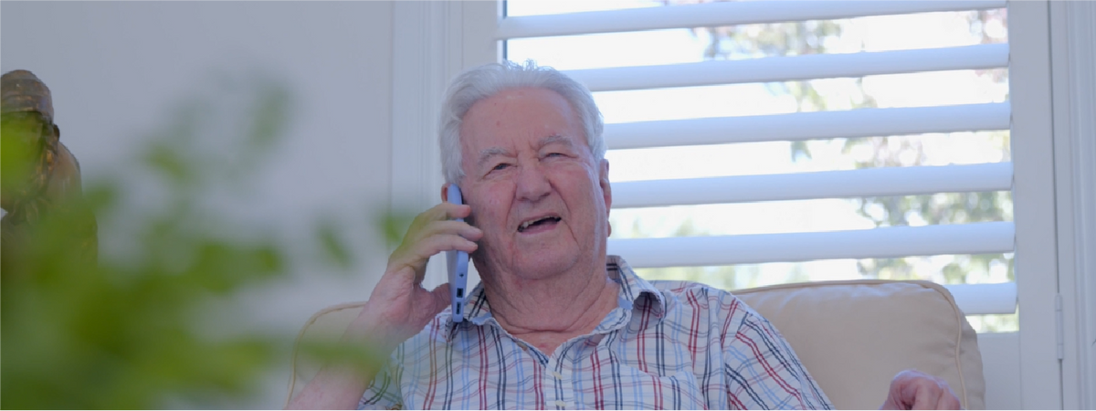 A happy senior citizen simply using a BigPurplePhone